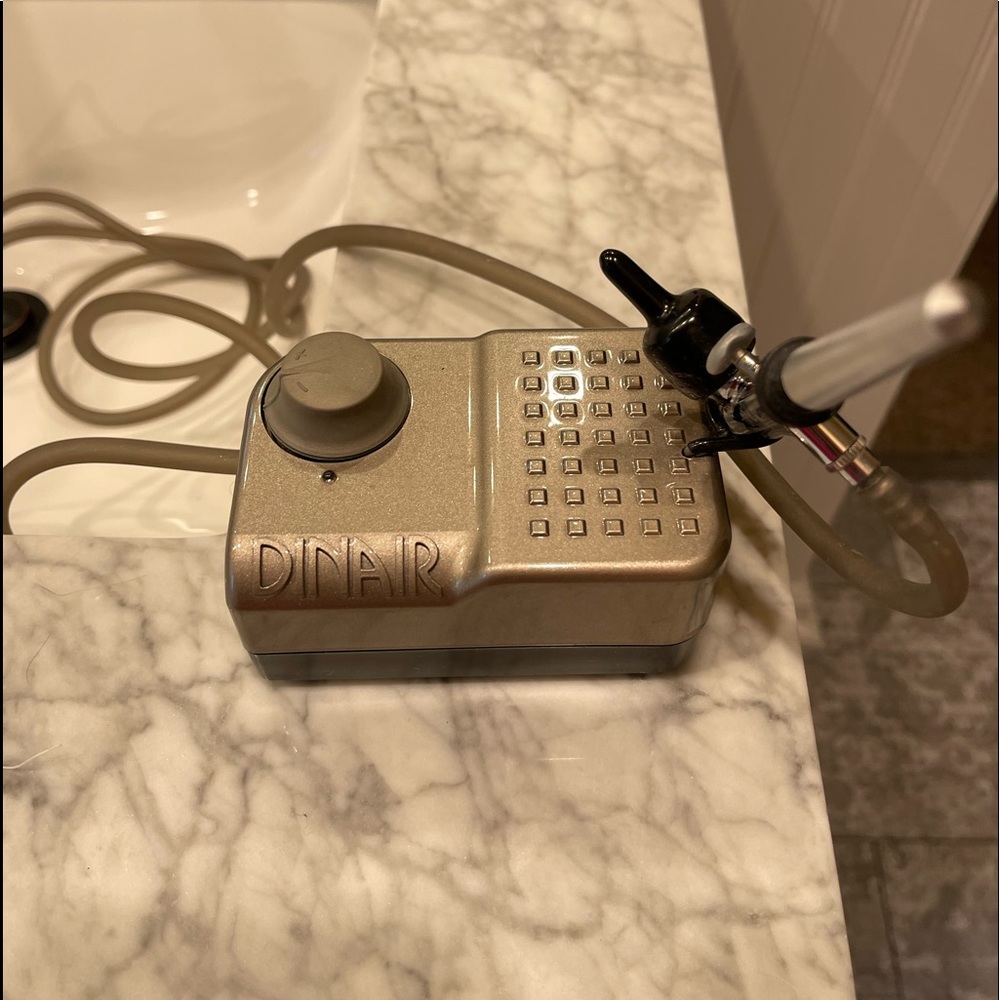 Dinair airbrush makeup (compressor) and one bottle of unused “light” tan
